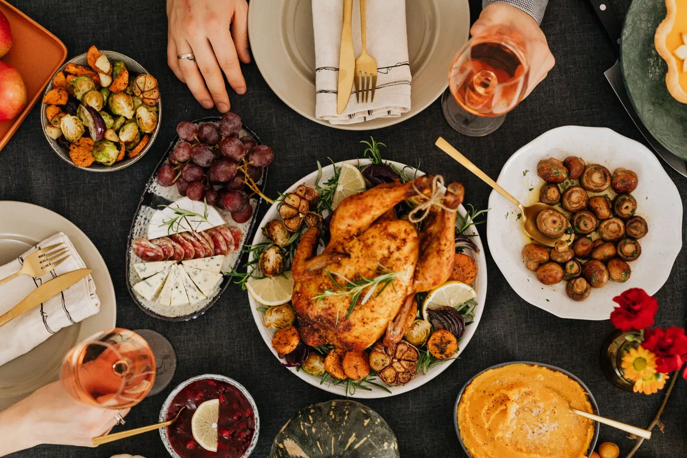 A roast chicken dinner and side dishes arranged on a household dining table