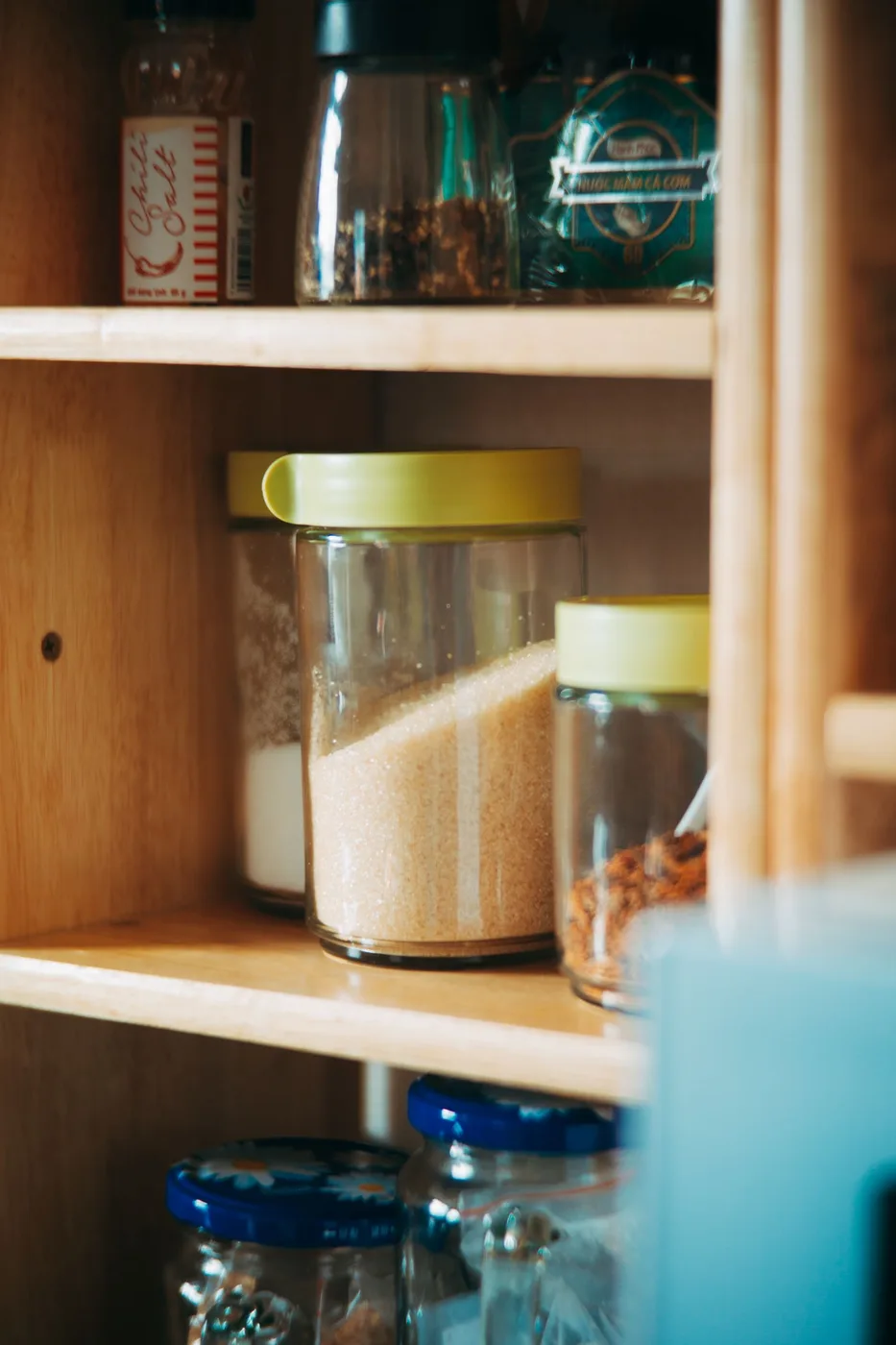 Kitchen pantry shelves holding glass jars of ingredients