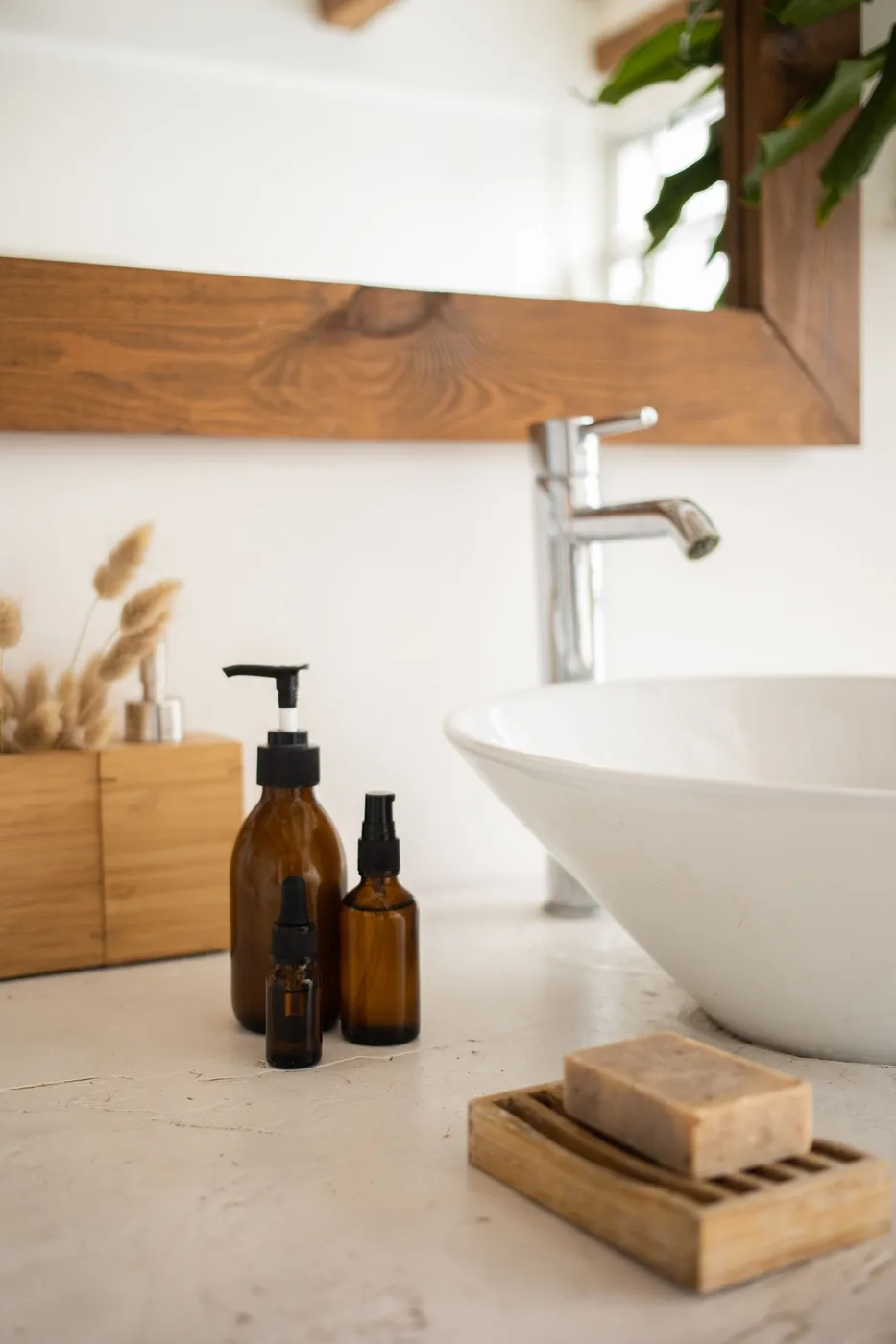 Daily care bottles arranged beside a bathroom sink